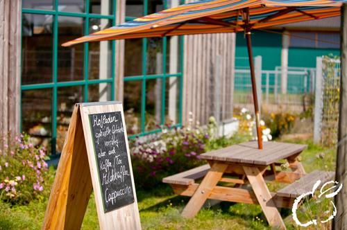 Het team van de boerderijwinkel kondigt actuele aanbiedingen en speciale lekkernijen aan op een bord voor de ingang