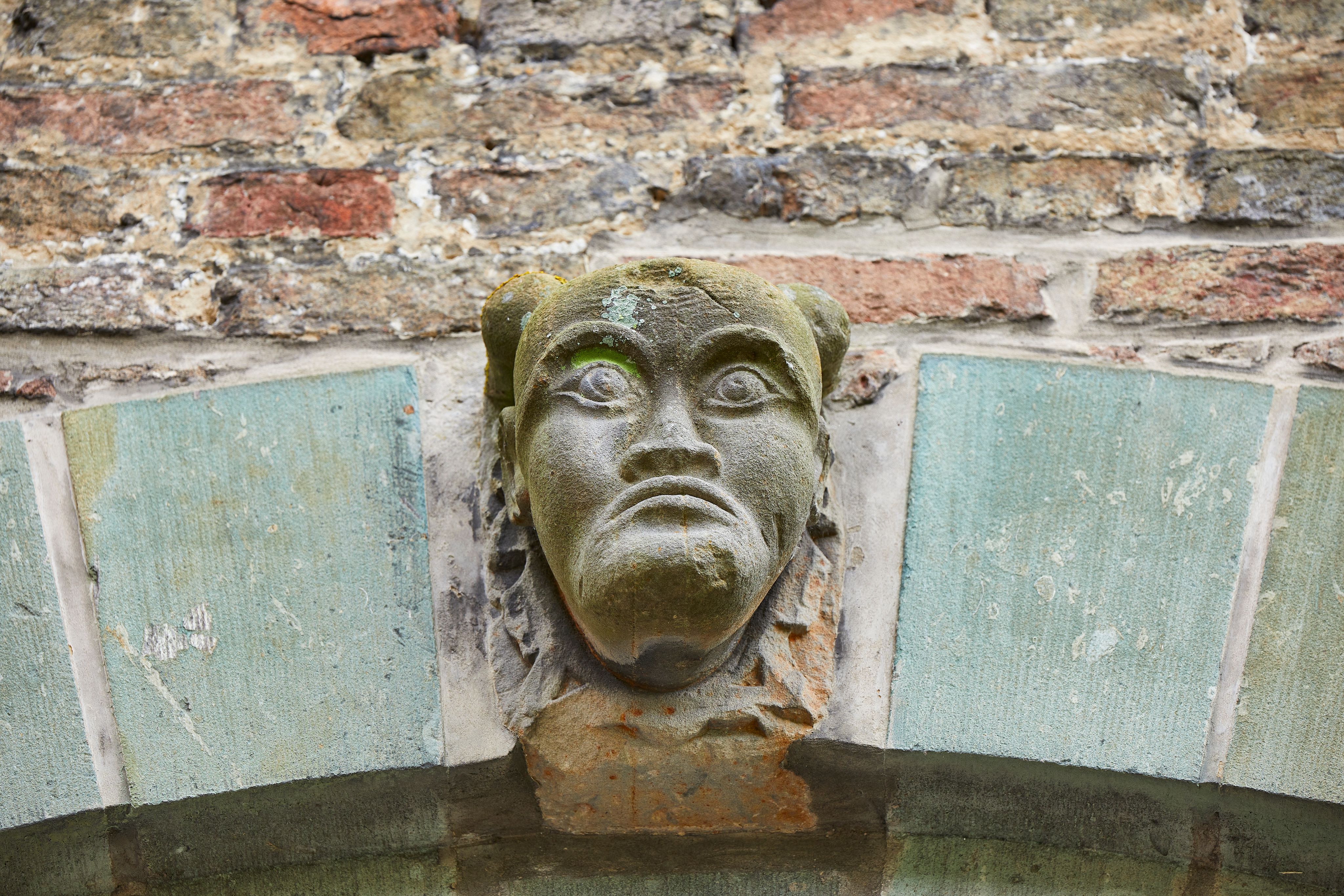 De muren en poorten van het Huis van Assen zijn versierd met maskers, leeuwenkoppen, wapenschilden en opschriften