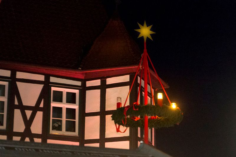 Een verlichte adventskrans voor een vakwerkhuis op de Sinterklaasmarkt in Hövelhof.
